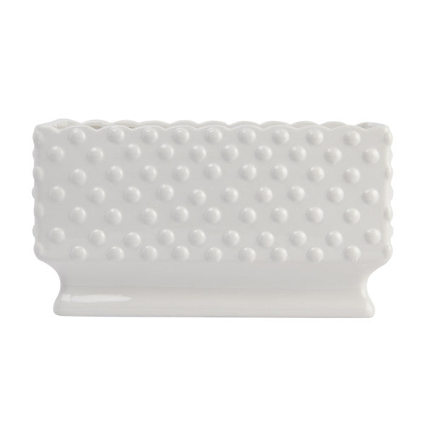 A white ceramic planter with a hobnail texture, scalloped edge, and polka dots.